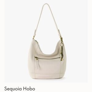 The Sac Sequoia Leather Hobo with Front Zip and Charm Detail Color "Stone"